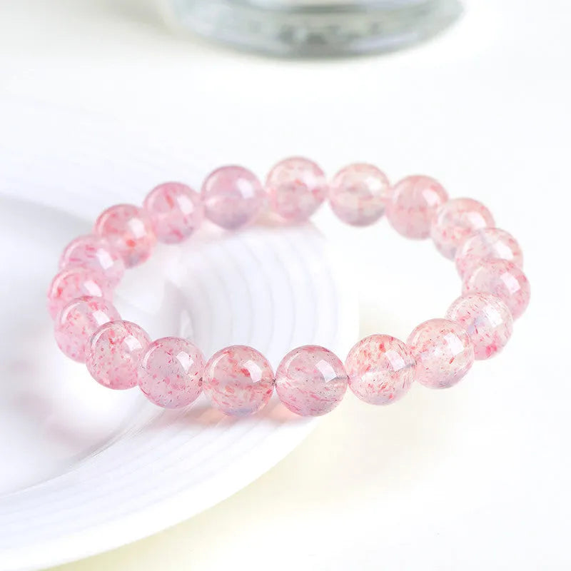 Strawberry quartz crystal bracelet with 10-10.8mm geometric balls in natural white water colour