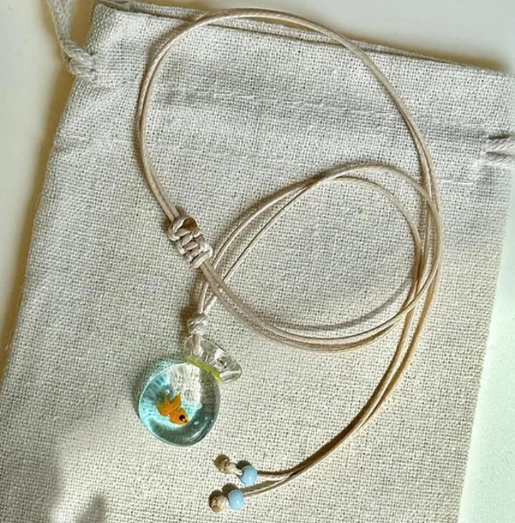 Women's world style necklace with coloured glaze joker pendant on a cotton linen clavicle chain.