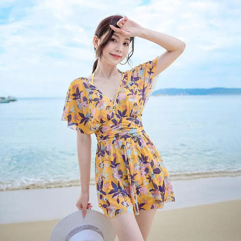 Yellow floral print women's one-piece swimsuit showing front design and polyester fabric construction