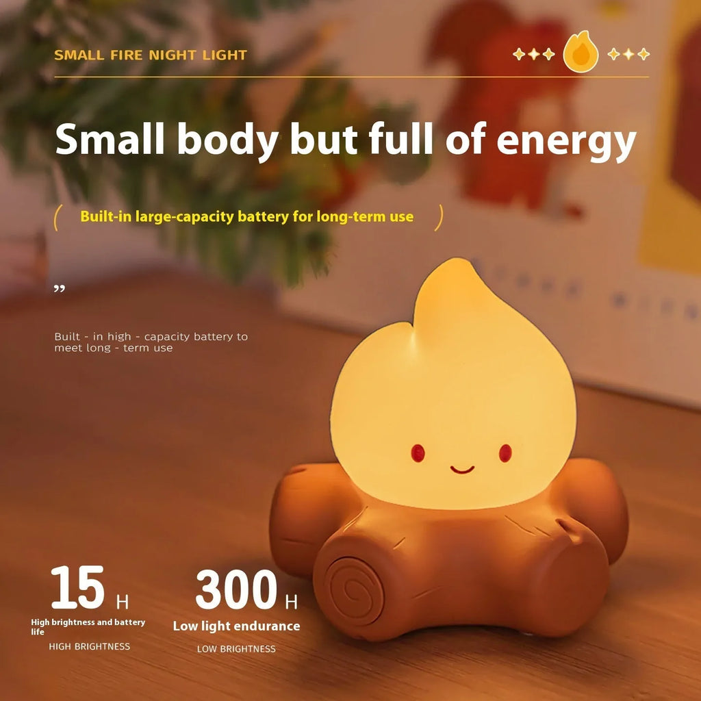 Small yellow silicone cartoon fire pile night lamp with ABS plastic shade on a table