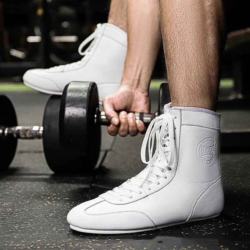 Professional black and gold mesh boxing shoe for indoor wrestling and training.
