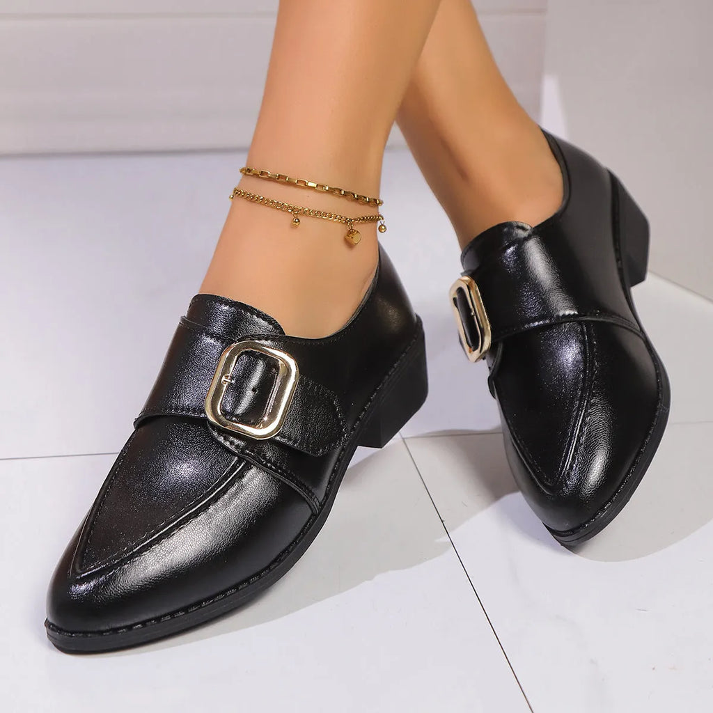Women's simple slip-on shoe in a British-style leather look with a choice of buckle or bow decoration on the upper.
