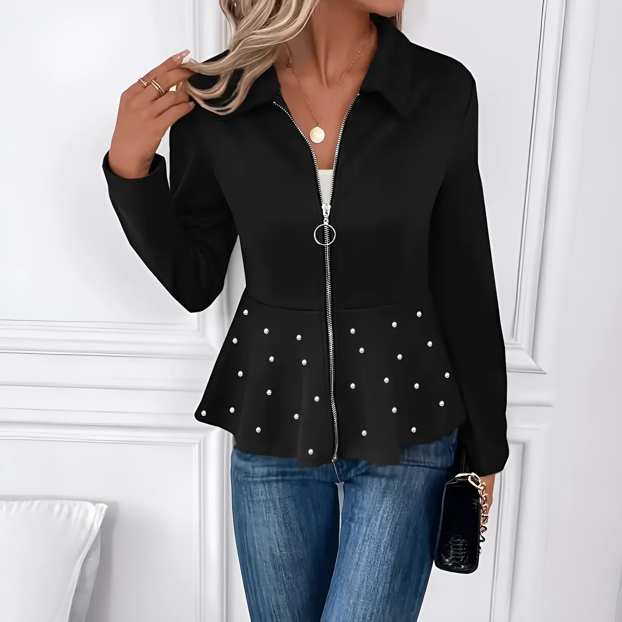 Women's black loose fit coat with a heavy-duty beaded zipper and a ruffled hem.