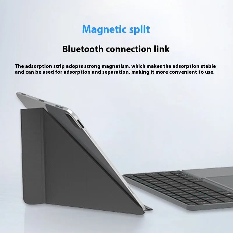 Grey wireless Bluetooth folding keyboard for mobile phones and tablets on a table.