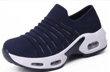 Stretch knitted mesh sock shoe for women in light grey colour with round toe and low heel.