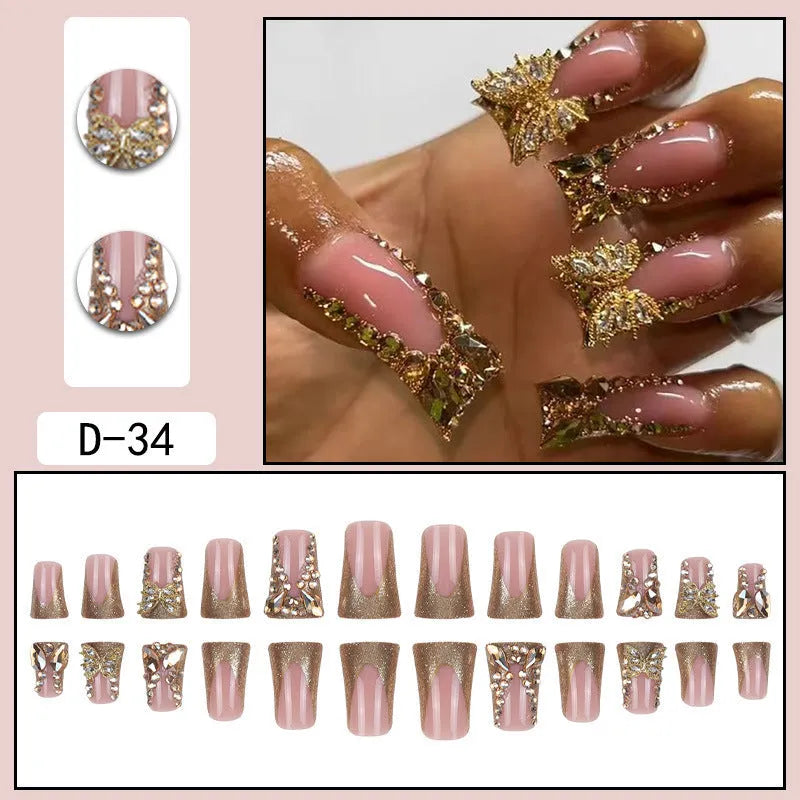 Pack of 24 golden diamond and debris-style butterfly nail stickers with a bottle of glue.