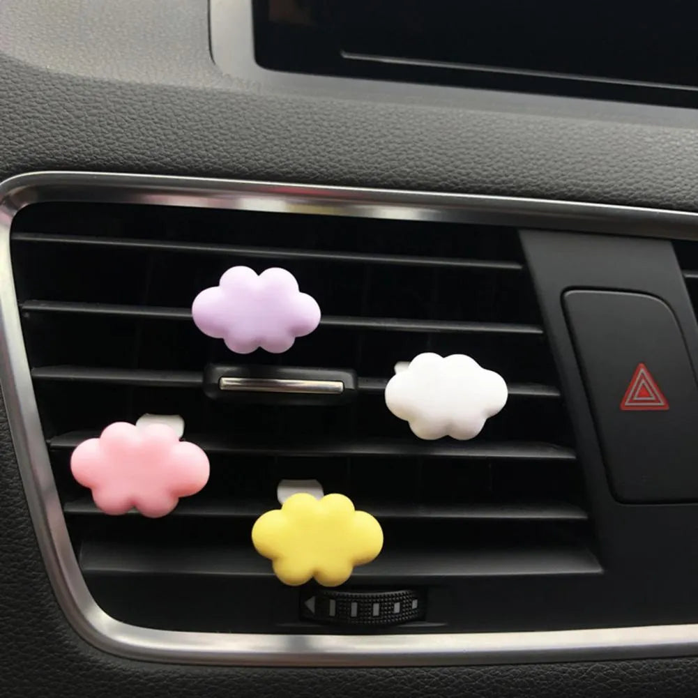 Resin Baiyun cartoon car fragrance clip in light green colour attached to a car air vent