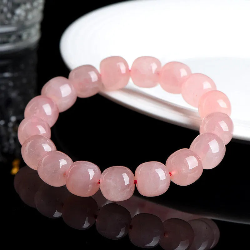 Natural pink crystal bracelet with geometric barrel-shaped beads measuring 8-10mm
