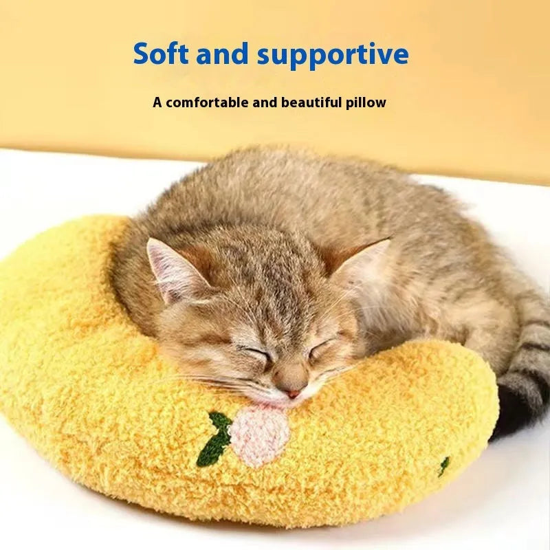 Blue and yellow U-shaped cloth pillows for cats in moon and question mark designs.