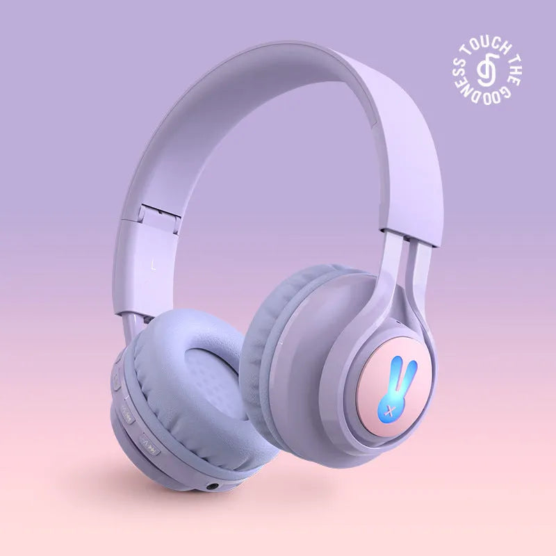 Wireless children's headphones with RGB LED lights in bunny pink colour showing illuminated ear cups