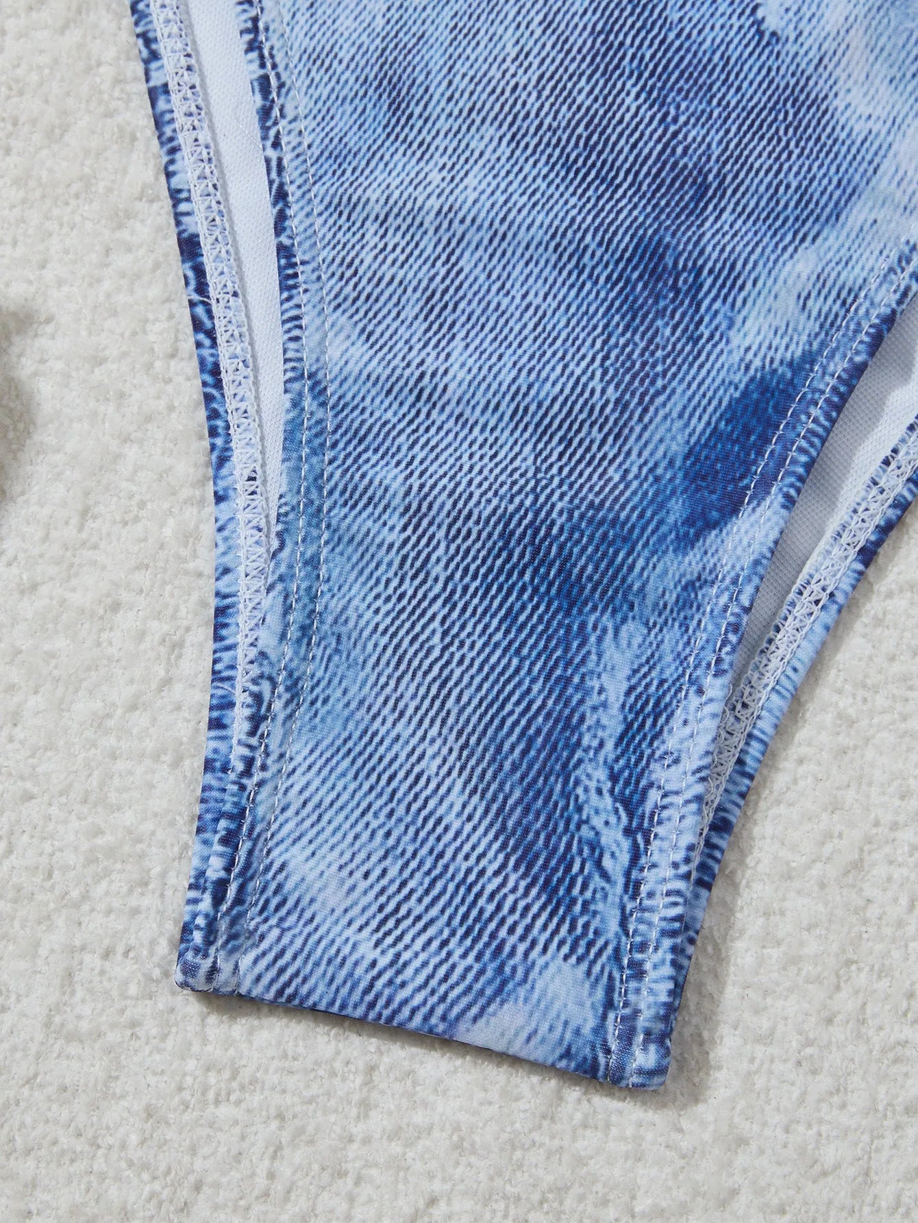 Denim blue printed women's bikini set with strap design, shown on a model.