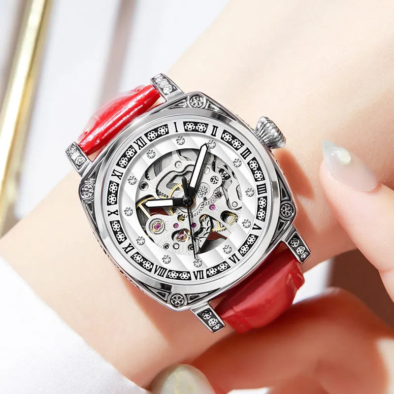Mechanical watch with luminous hands on a leather strap, shown in black, red, steel, and white colour variants.