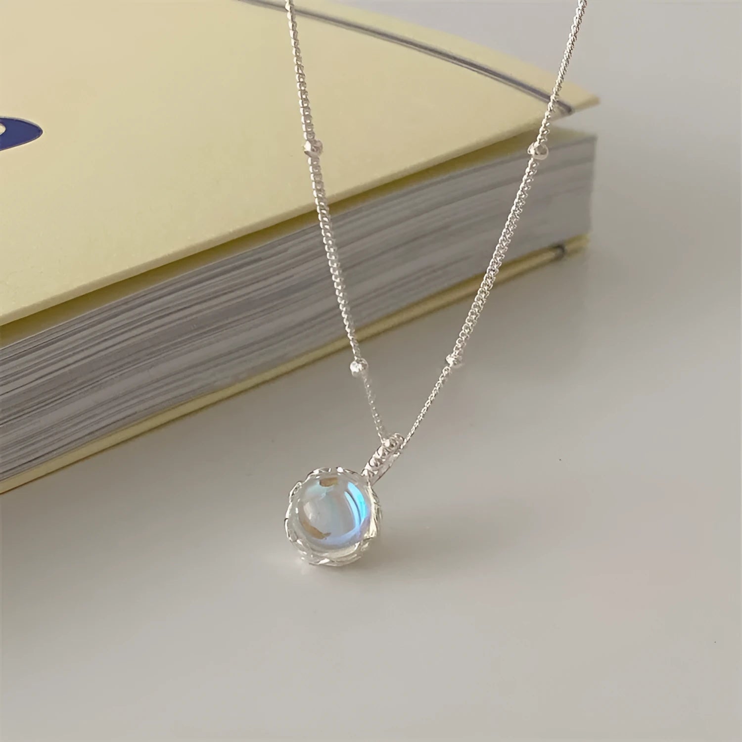 Geometric ornamental stone pendant on a 925 sterling silver curb chain necklace for women.