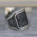 Black alloy ring with copper inlay and zircon detailing on a finger, showing ring sizes 7 to 13.
