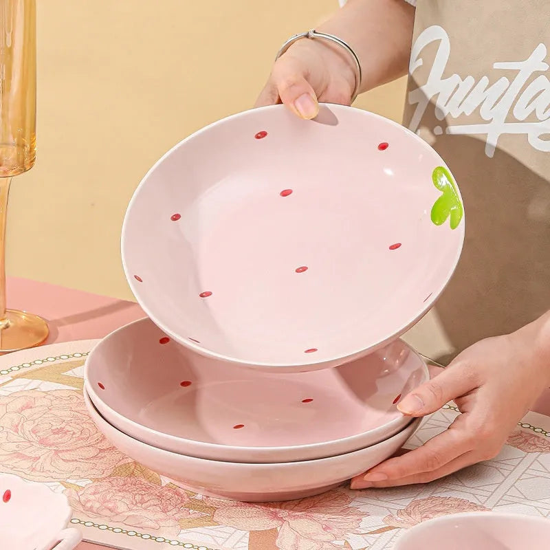 Strawberry design porcelain dinnerware set with plates, bowls, and twist spoon