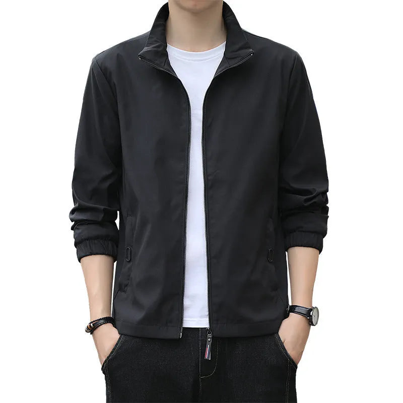 Man wearing a loose-fit grey Korean-style lapel casual jacket with zipper pockets.