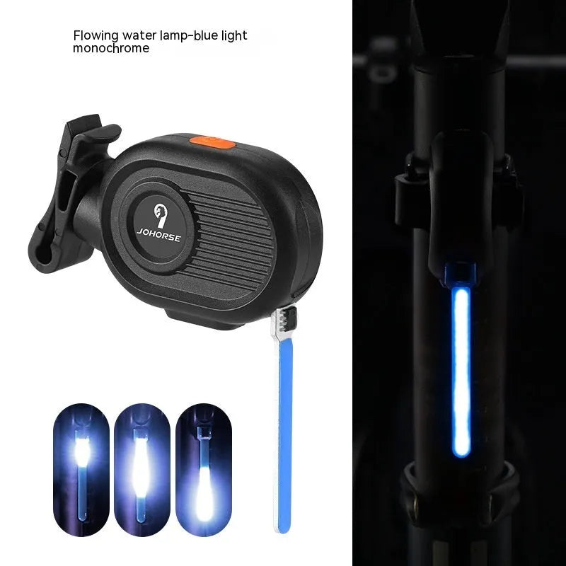 Bicycle taillight displaying a blue waterfall or running water light effect on a dark background.