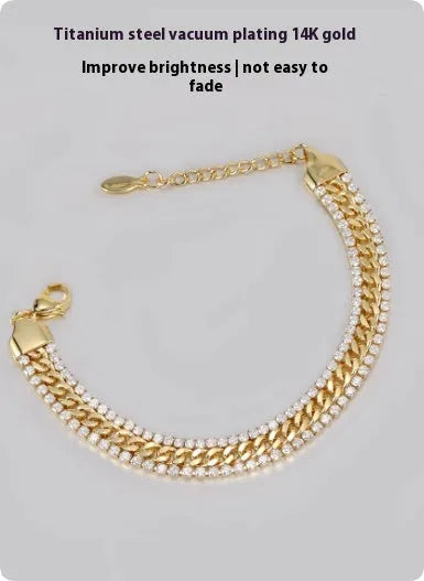 Gold-coloured titanium steel tennis bracelet with artificial gemstone inlay and a clasp.