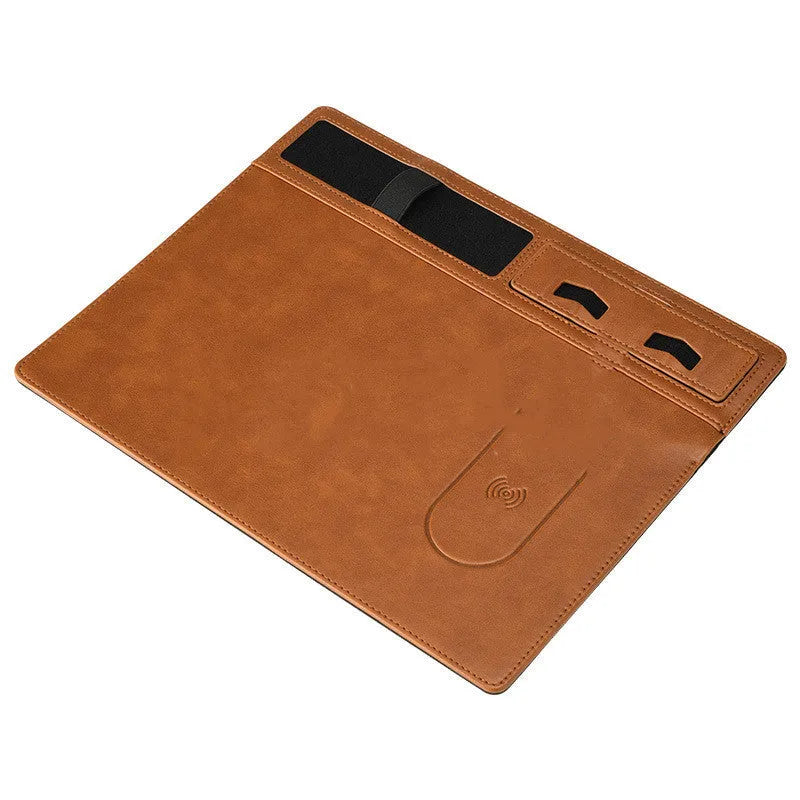 Pink wireless charging mouse pad with mobile phone holder on a desk
