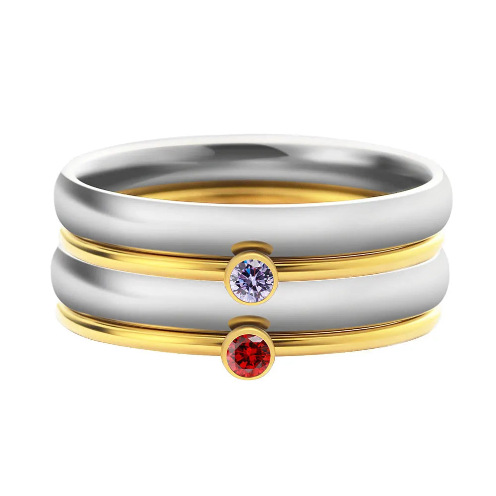 Geometric titanium steel ring with engraved detail and December birthstone colours on a white background