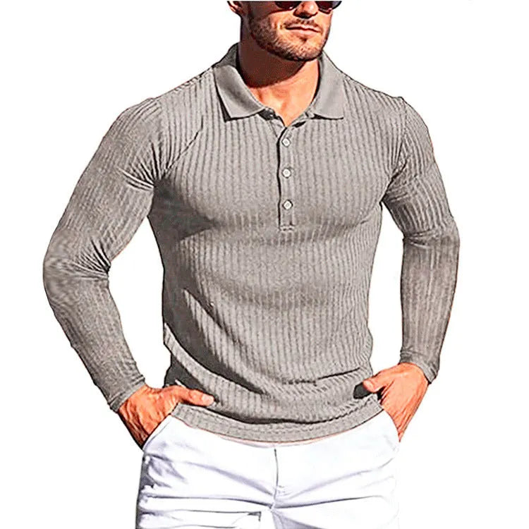 A striped, short sleeve, loose-fit knit shirt in Army Green on a hanger.
