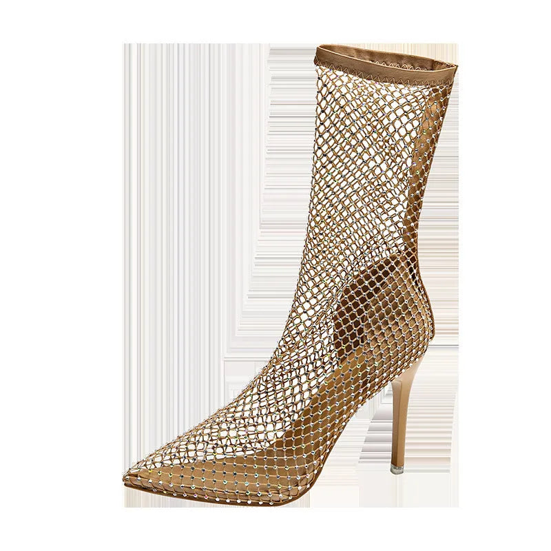 Gold high heel sandals with mesh upper and pointed stiletto heel on a rubber sole.