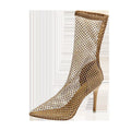 Gold high heel sandals with mesh upper and pointed stiletto heel on a rubber sole.
