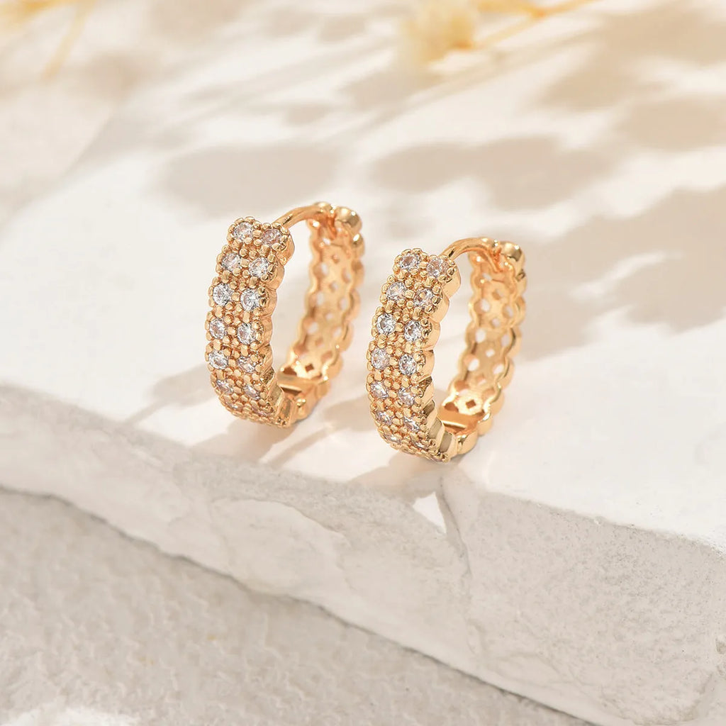 Geometric pattern copper ear studs in colour DE20288 showing round, dot, and ring design elements.