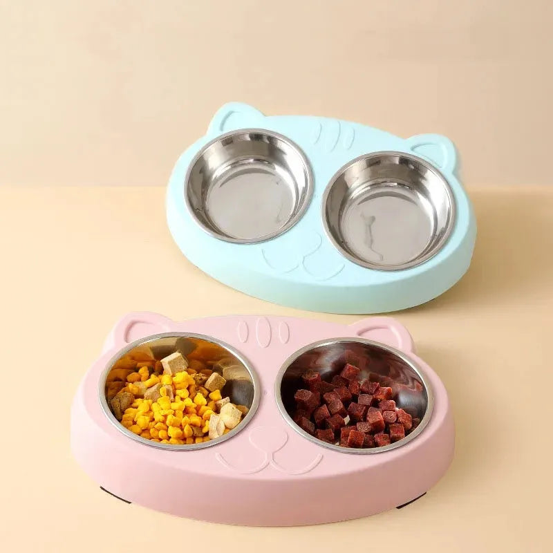 Blue plastic macaron-shaped double bowl pet feeder tray with a non-slip base and centre divider.
