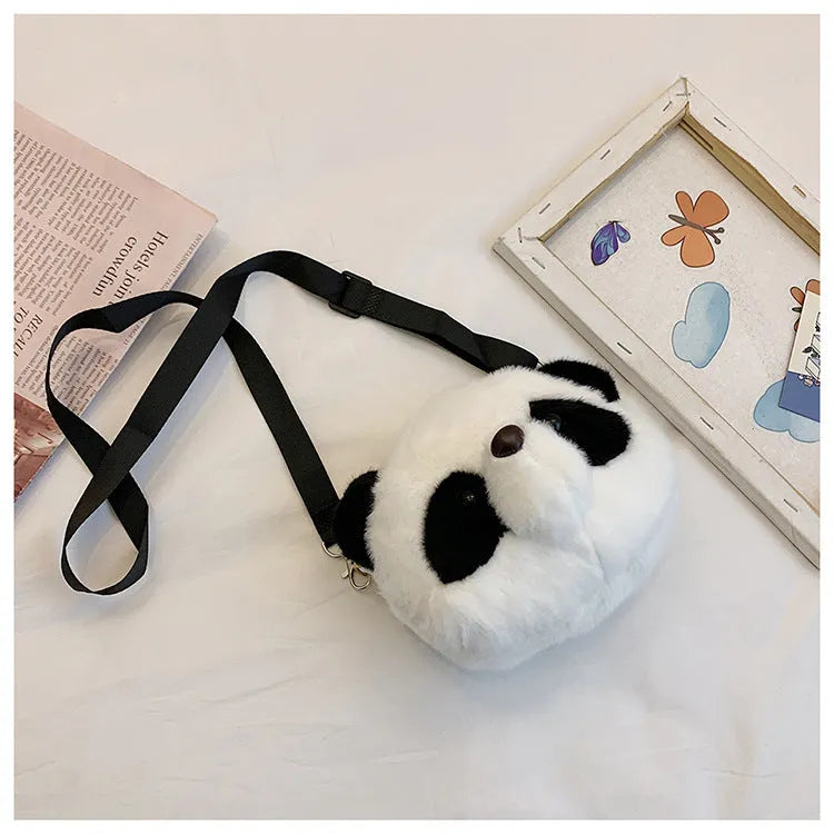 Soft plush cylindrical crossbody bag in panda head design with a sandwich pocket.