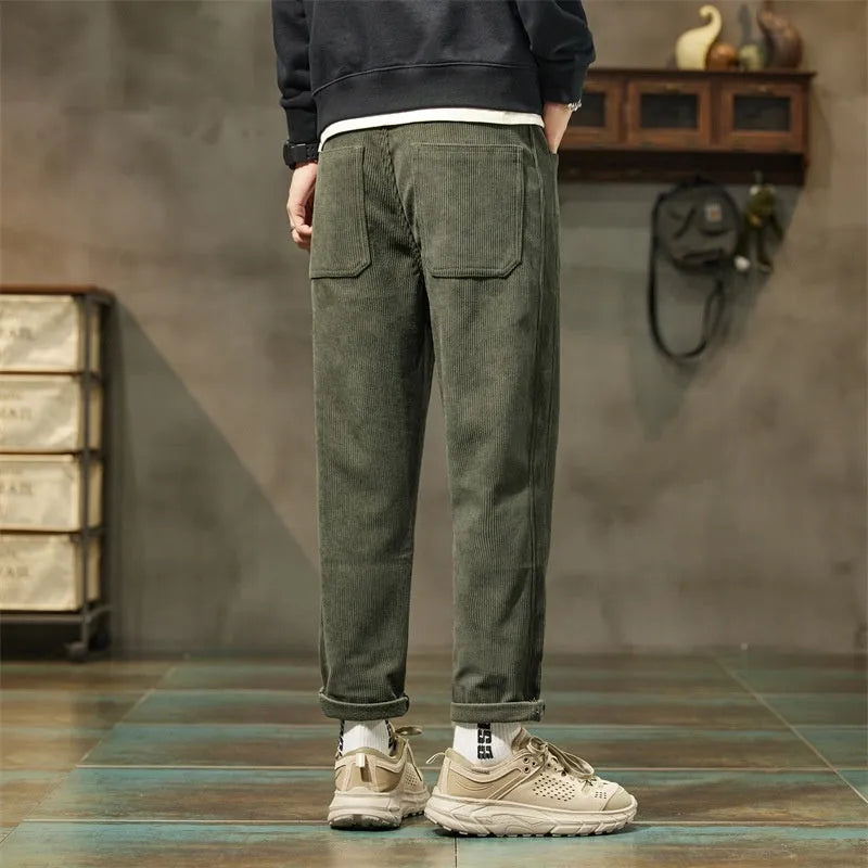 Men's army green corduroy casual trousers with a tapered straight-leg fit on a mid waist.