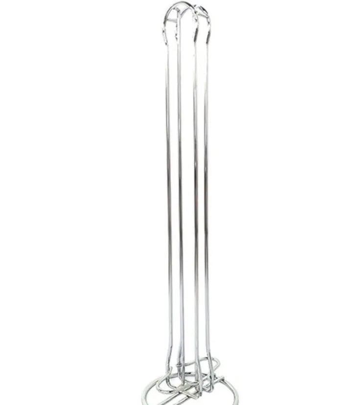 A black wrought iron coffee capsule storage rack holding pods on a kitchen counter.