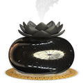 Pure black lotus-shaped USB aromatherapy humidifier on a desk.