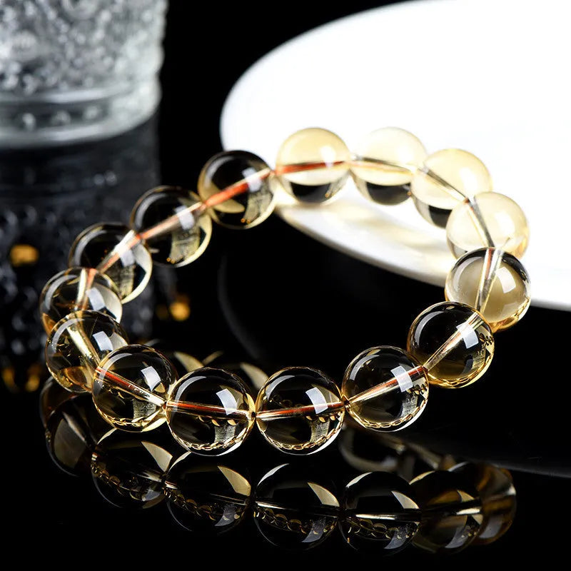 Natural citrine scattered beads ball bracelet showing polished stones on wrist.