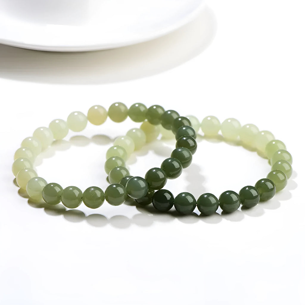 Natural gradient water Hetian jade bead bracelet showing round and barrel bead options on an adjustable string.
