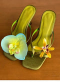Women's handmade asymmetric flower design sandals in calf leather with a high heel and square toe.