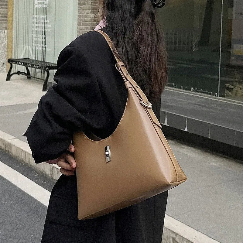Genuine leather dumpling-shaped crossbody shoulder bag in apricot colour with street-trend details.