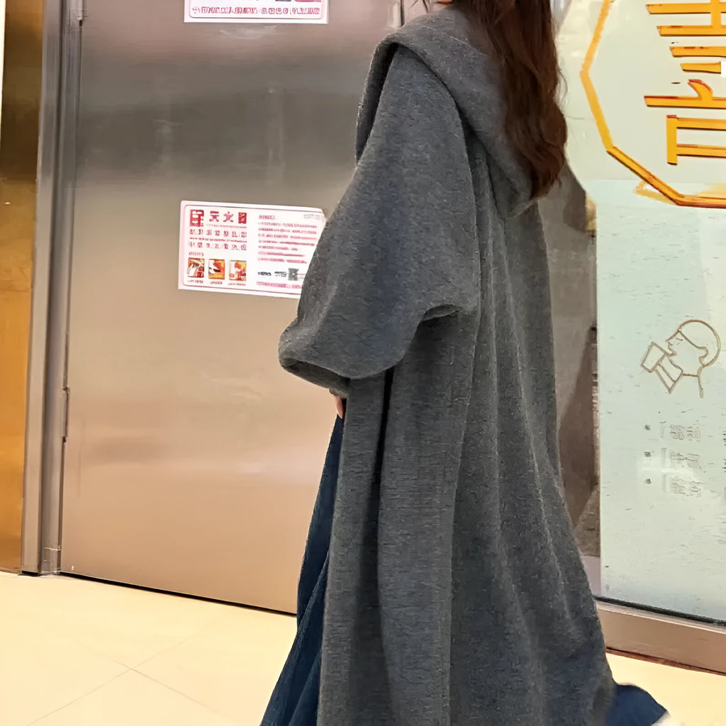Women's long brown hooded knitted cardigan with a below-the-knee length and loose fit.