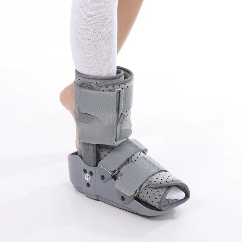 Black adjustable Achilles tendon rehabilitation boot with aluminium struts, shown on a foot.