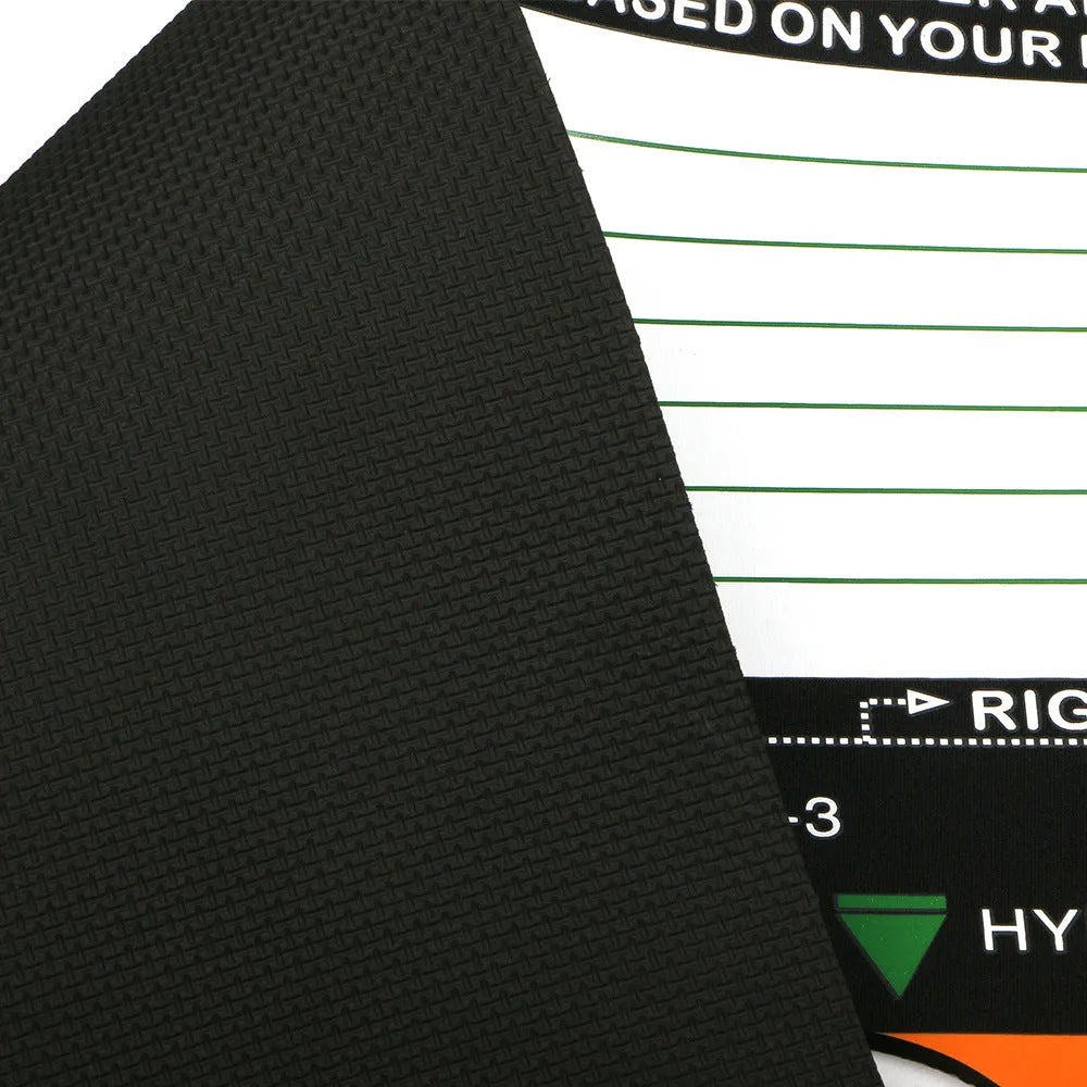 Black neoprene golf swing stance alignment pad on grass