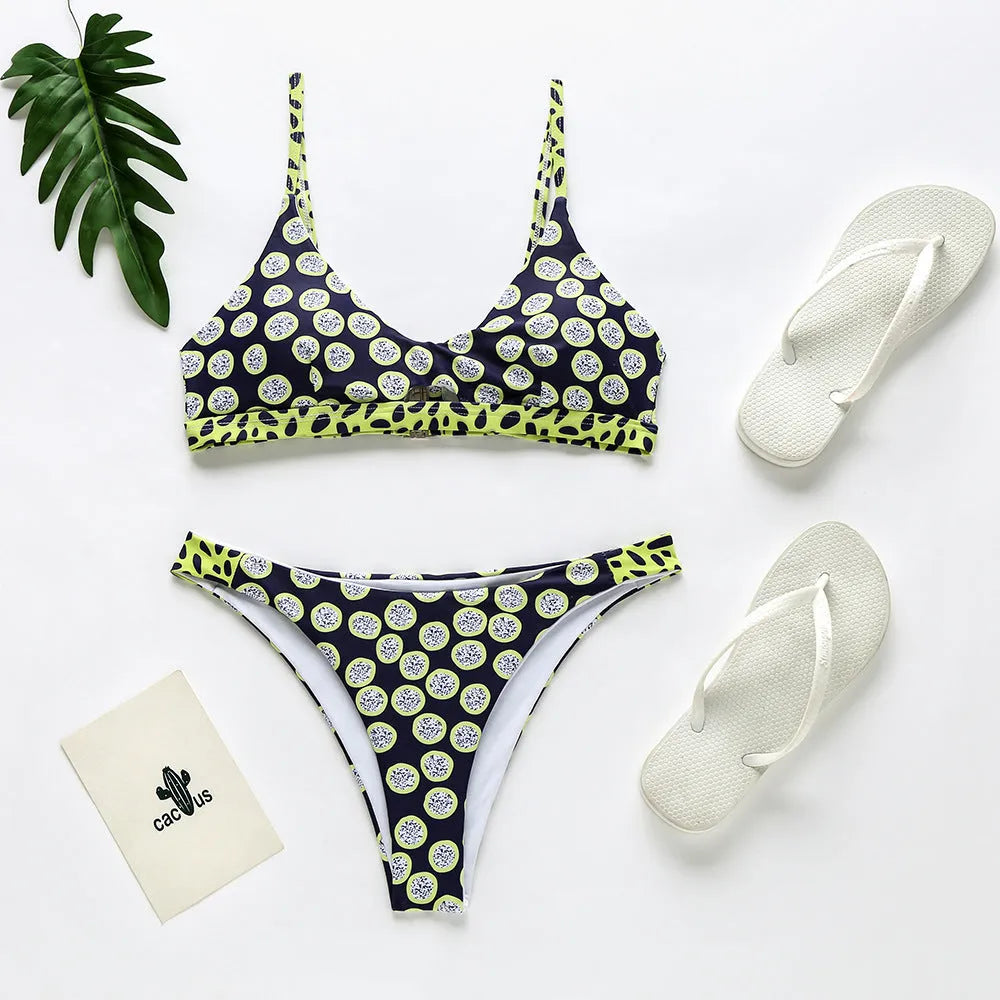 Women's bikini swimsuit in black and white dot pattern, made from polyester fabric.