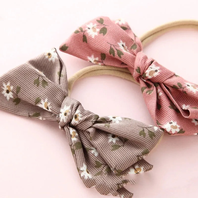Children's cloth hair band with knotted bow design showing Snow White princess pattern