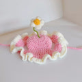 Knitted cartoon-style hat for a cat or small dog on a green background