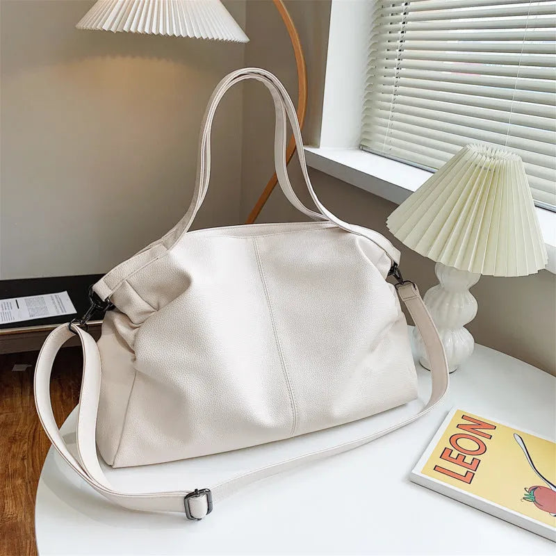 Large soft-surface PU messenger tote bag in black with zipper opening and adjustable shoulder strap