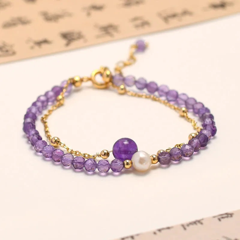 Close-up of a Chinese style women's bracelet with diamond-shaped amethyst crystals and an electroplated finish.