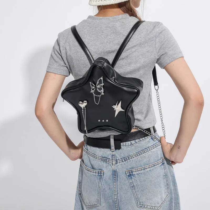 Soft black PU women's mini backpack worn across the body as a messenger bag.