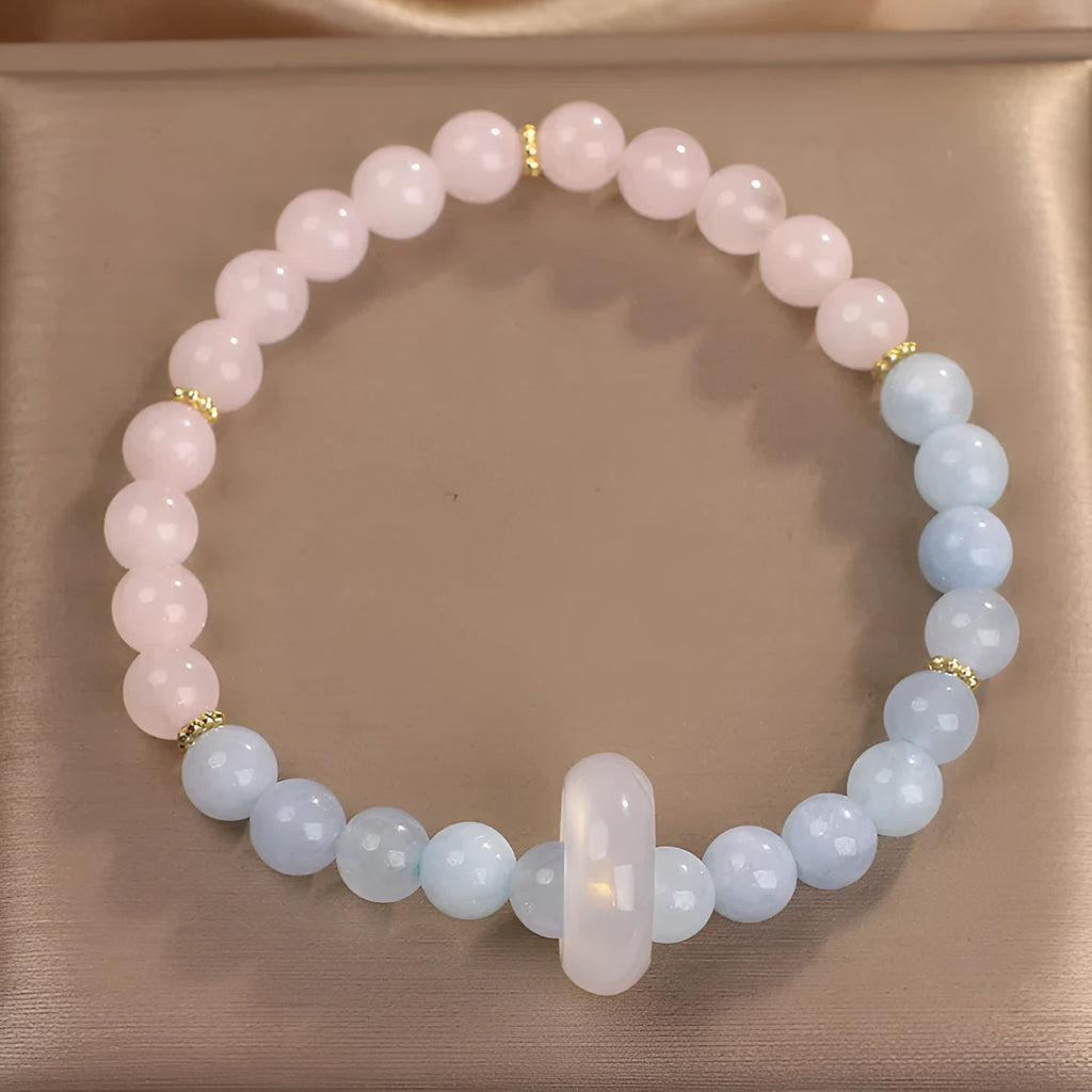 Natural aquamarine crystal beaded bracelet with pink electroplated finish on display