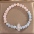Natural aquamarine crystal beaded bracelet with pink electroplated finish on display