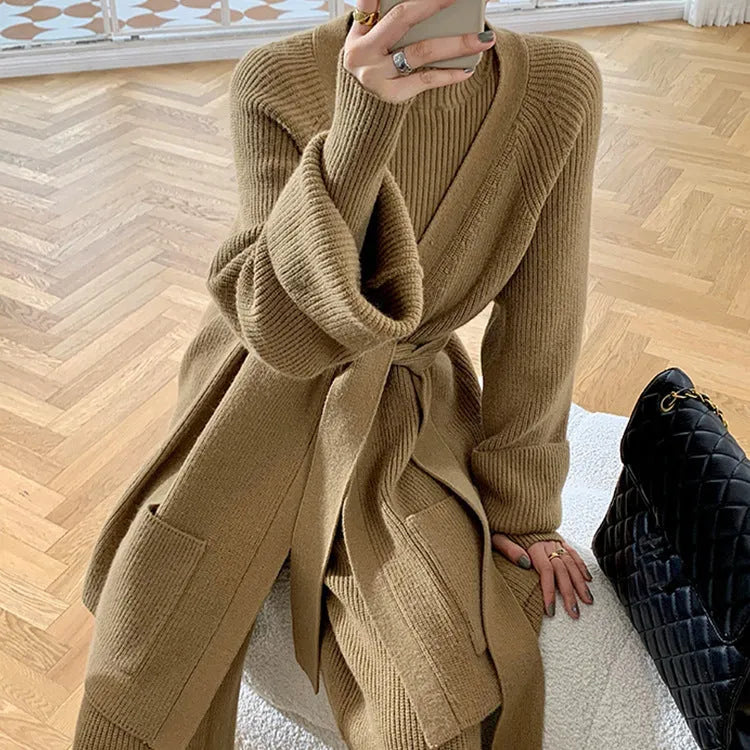Women's apricot knitted three-piece set with cardigan, sweater, and wide-leg trousers on a hanger.