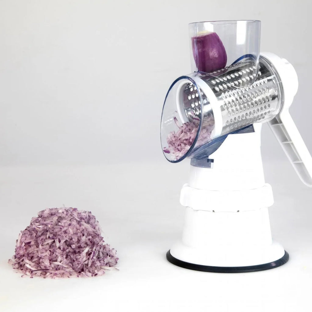 White plastic manual 3-in-1 vegetable slicer grater with stainless steel blades on a kitchen counter.
